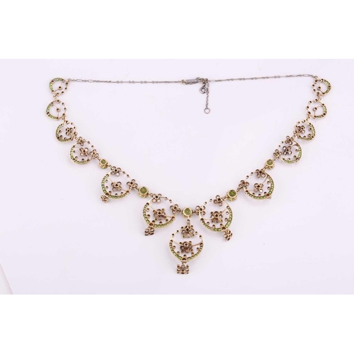 48 - An Edwardian diamond, peridot and demantoid garnet necklace, circa 1910, the floral garland design s... 