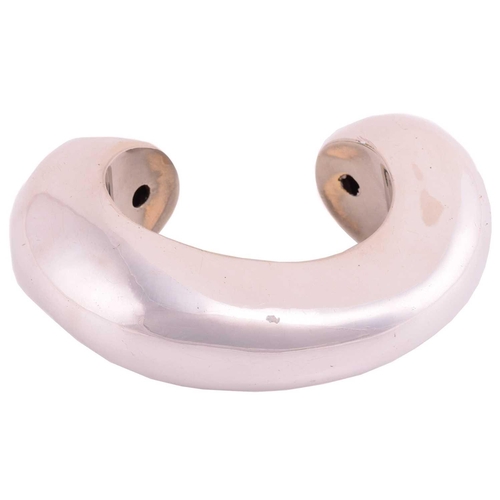 62 - Patricia Von Musulin - a large open cuff bracelet of biomorphic form, polished white metal stamped '... 