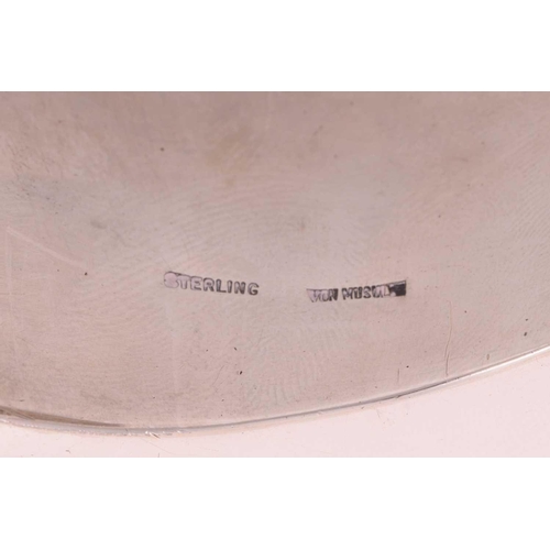 62 - Patricia Von Musulin - a large open cuff bracelet of biomorphic form, polished white metal stamped '... 