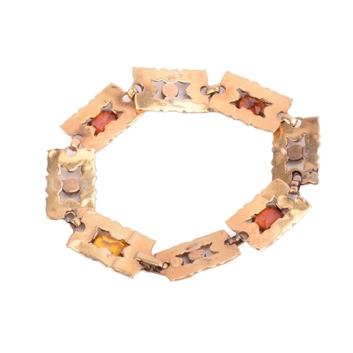 67 - An Art Nouveau gem-set bracelet, eight rectangular links repoussé and chased with floral and scrollw... 