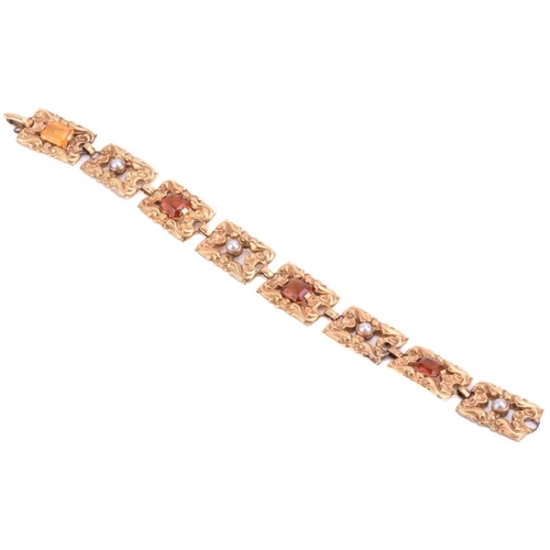 67 - An Art Nouveau gem-set bracelet, eight rectangular links repoussé and chased with floral and scrollw... 