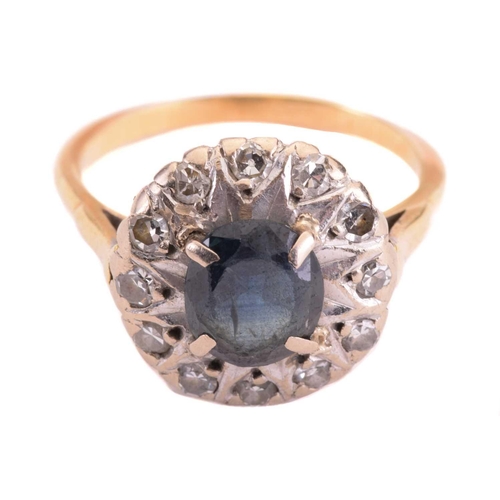69 - A sapphire and diamond cluster ring, set to the centre with a sapphire measuring 7.9 x 6.6mm, encirc... 