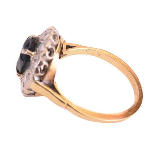 69 - A sapphire and diamond cluster ring, set to the centre with a sapphire measuring 7.9 x 6.6mm, encirc... 