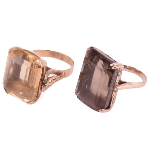 7 - Two large quartz cocktail rings; the first comprises an octagonal step-cut smokey quartz of brown co... 