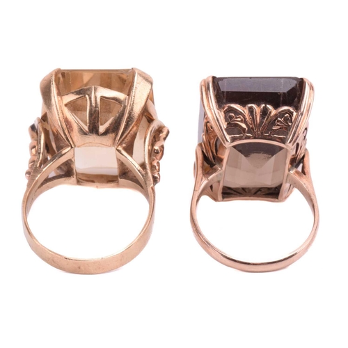 7 - Two large quartz cocktail rings; the first comprises an octagonal step-cut smokey quartz of brown co... 