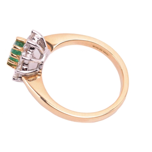 78 - An 18 carat gold, emerald and diamond cluster ring; the oval cut emerald in claw mounts above a bord... 