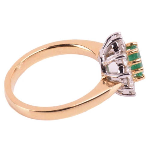 78 - An 18 carat gold, emerald and diamond cluster ring; the oval cut emerald in claw mounts above a bord... 
