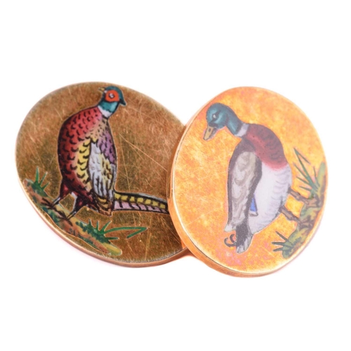 93 - A pair of game birds cufflinks in 9ct yellow gold, each oval panel depicting an enamelled scene of a... 