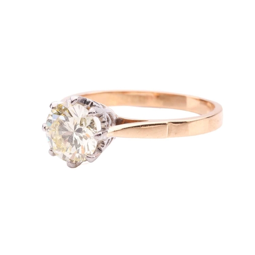 94 - A diamond solitaire ring set with a light yellow round brilliant cut diamond with an estimated weigh... 