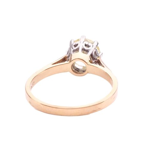 94 - A diamond solitaire ring set with a light yellow round brilliant cut diamond with an estimated weigh... 