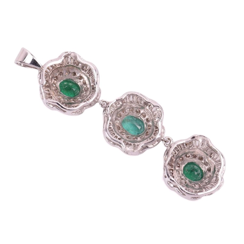 96 - A suite of emerald and diamond flowerhead pendants; two identical flowerhead clusters each centred w... 