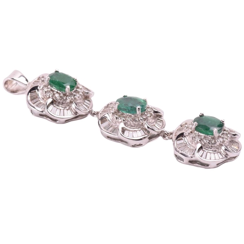 96 - A suite of emerald and diamond flowerhead pendants; two identical flowerhead clusters each centred w... 