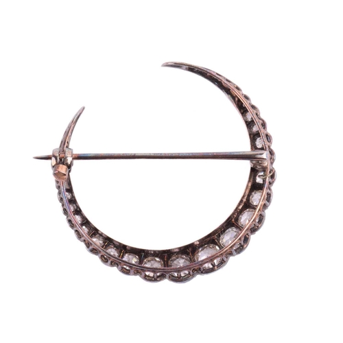 98 - An Early 20th-century diamond crescent brooch, set with nineteen graduated old-cut diamonds, with an... 