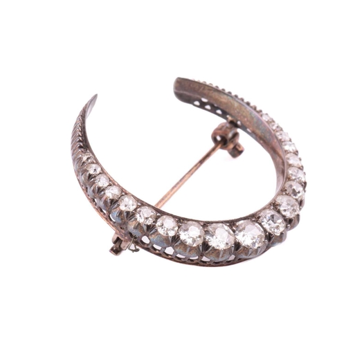 98 - An Early 20th-century diamond crescent brooch, set with nineteen graduated old-cut diamonds, with an... 