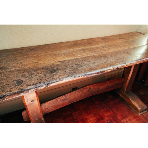 112 - An oak plank-top vernacular refectory/tavern table, early 18th century and later, with clamped plank... 