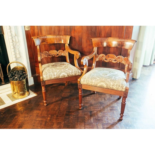 113 - A pair of 19th century Continental mahogany open armchairs, with curved top rails and fan carved mid... 