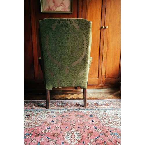 125 - A George II green-upholstered wing armchair, on walnut cabriole legs, old repairs, 111 cm high x 77 ... 