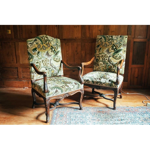 134 - A near pair of 18th-century style French mahogany open armchairs, the upholstered rectangular backs ... 