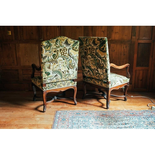 134 - A near pair of 18th-century style French mahogany open armchairs, the upholstered rectangular backs ... 