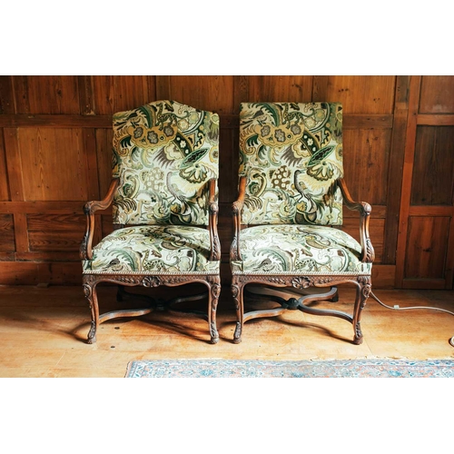 134 - A near pair of 18th-century style French mahogany open armchairs, the upholstered rectangular backs ... 