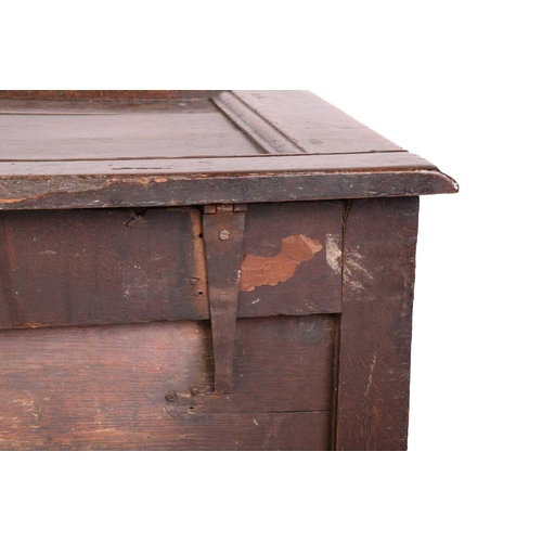 139 - An early 18th-century oak coffer, hinged panel top and a later carved panel front, 126 cm wide x 62 ... 