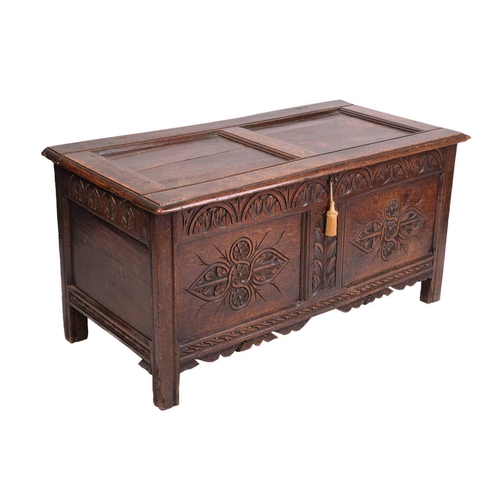 139 - An early 18th-century oak coffer, hinged panel top and a later carved panel front, 126 cm wide x 62 ... 