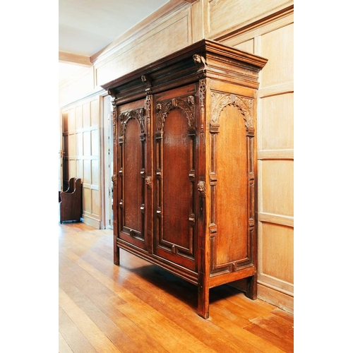 14 - An 18th-century Dutch oak Schrank, the moulded cornice above a pair of arched panel doors, accented ... 