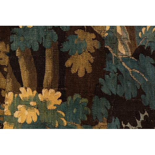 141 - A 17th-century Flemish verdure tapestry fragment, a woodland setting, later linen backed, 141 cm x 1... 