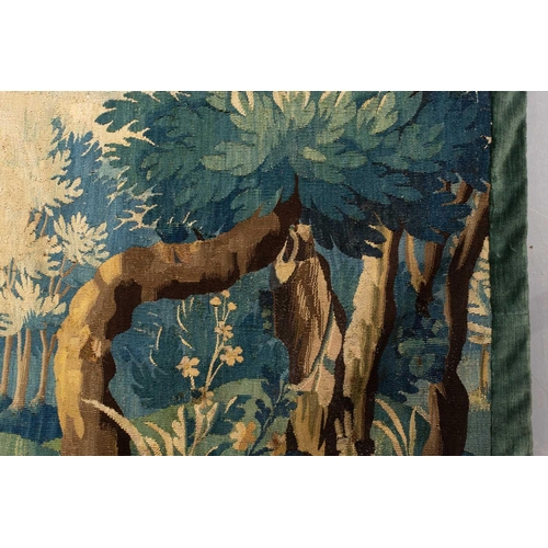 141 - A 17th-century Flemish verdure tapestry fragment, a woodland setting, later linen backed, 141 cm x 1... 