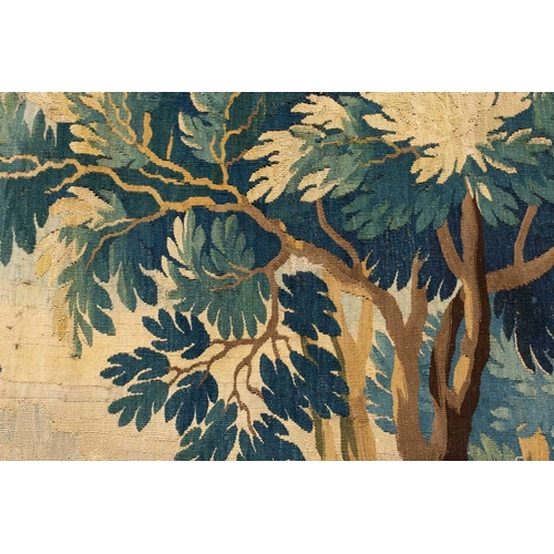 141 - A 17th-century Flemish verdure tapestry fragment, a woodland setting, later linen backed, 141 cm x 1... 