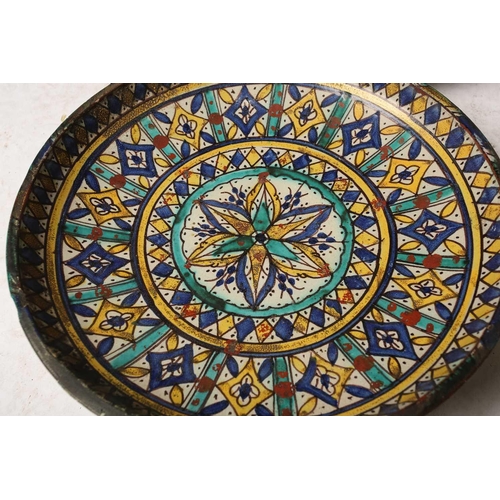 148 - An Eastern tin-glazed footed circular dish possibly Moroccan Fez late 19th/20th century, painted in ... 