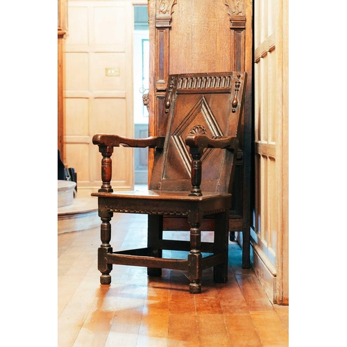 15 - A 17th-century oak wainscot chair, with carved panel back and panel seat, on turned stretched suppor... 