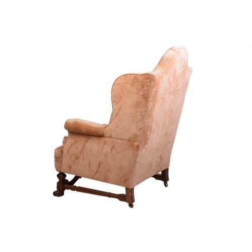 152 - A William & Mary style upholstered wingback fireside chair with a high stepped arched back, roll-ove... 