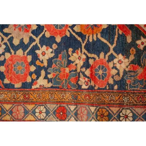 162 - An antique large Mahal runner with dark blue ground a trellis of large flower heads and a central di... 