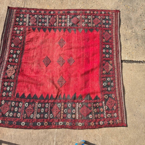 165 - A red ground Baktiari carpet, with an allover compartmented design within multiple borders, 302 cm x... 