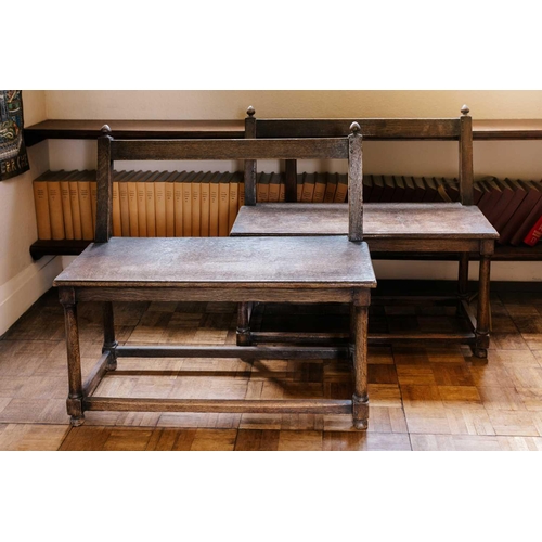 166 - A close pair of rustic oak window seats, French, 19th century with open backs over solid seats and t... 