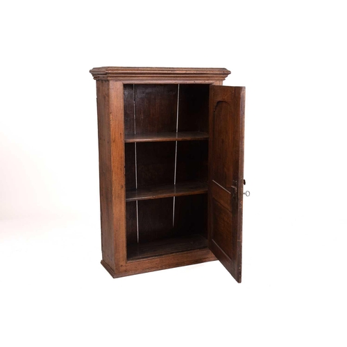 169 - A 19th century oak hanging cupboard, with twin panelled door enclosing shelves, 66 cm wide, 103 cm h... 