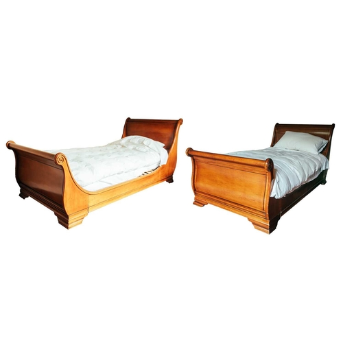 172 - A pair of 'And So To Bed' French-style cherrywood single sleigh beds with scroll ends and sprung sla... 