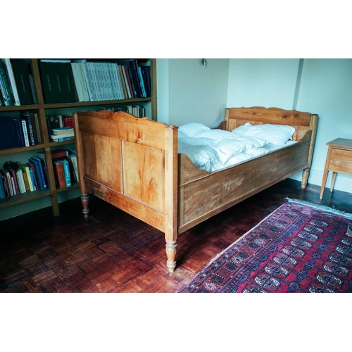 198 - A pair of French fruitwood single sleigh beds, 19th century and later adaptations with panelled ends... 