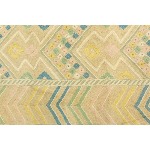 199 - A large 'Mid-Century Vintage' style needlework rug in geometric patterns with muted tones of ochre a... 