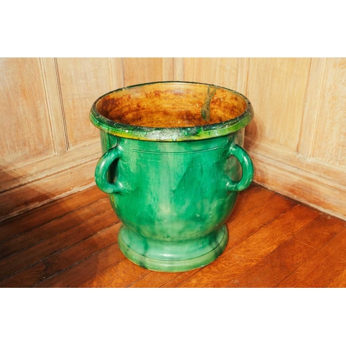 23 - A modern green glazed ceramic planter, with four loop handles, 51 cm high x 45 cm wide, together wit... 