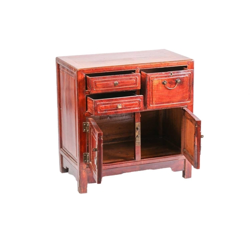 256 - A Chinese hardwood chest, with two short drawers beside a deep drawer over a pair of cupboard doors,... 