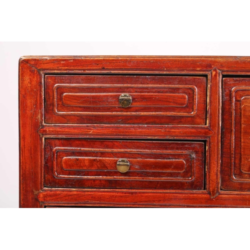 256 - A Chinese hardwood chest, with two short drawers beside a deep drawer over a pair of cupboard doors,... 