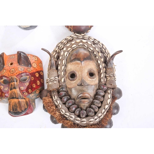 262 - A collection of sixteen polychrome carved wood face masks, from Guatemala, India, Africa and the Far... 