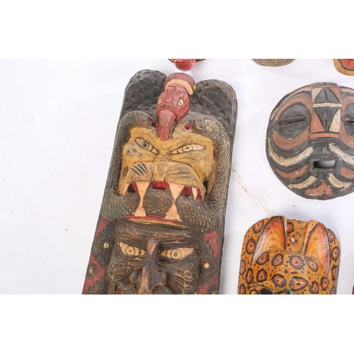 262 - A collection of sixteen polychrome carved wood face masks, from Guatemala, India, Africa and the Far... 