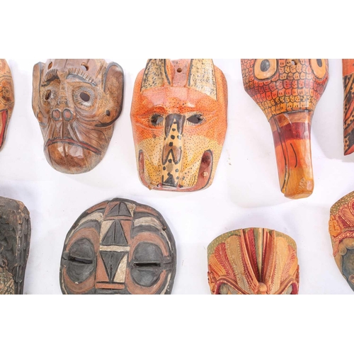 262 - A collection of sixteen polychrome carved wood face masks, from Guatemala, India, Africa and the Far... 