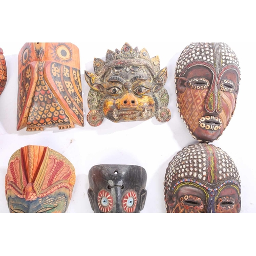 262 - A collection of sixteen polychrome carved wood face masks, from Guatemala, India, Africa and the Far... 