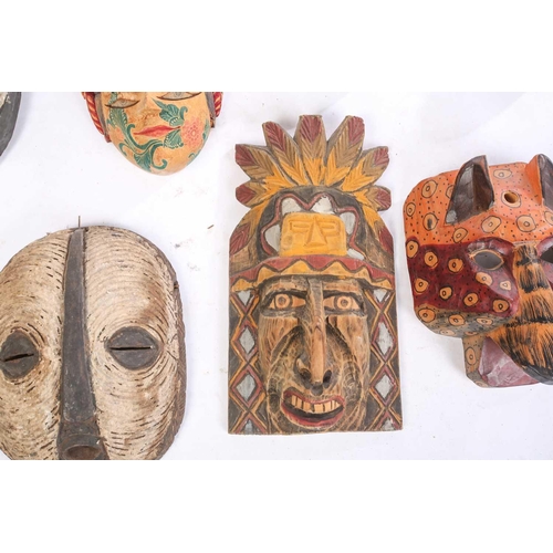 262 - A collection of sixteen polychrome carved wood face masks, from Guatemala, India, Africa and the Far... 