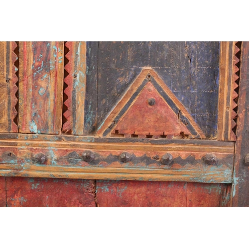 273 - A painted softwood Morrocan Door, of panelled construction with metal studs, the arched and serrated... 