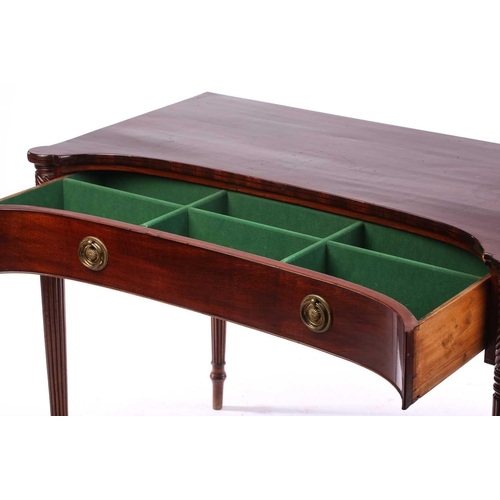 274 - A Regency style mahogany concave front side table, the top with rounded corners over a frieze drawer... 